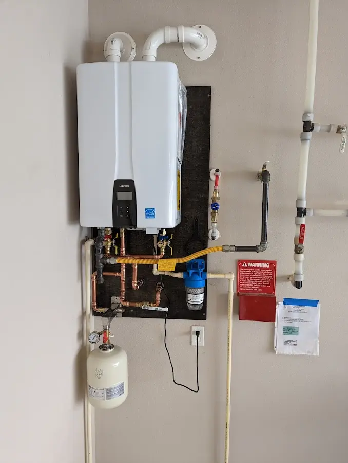 Professional plumber installing copper piping in a Oostburg home